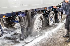 Mobile truck wash technician cleaning cab and chassis on-site in Sydney